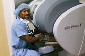 Photograph of a surgeon at the controls of the da Vinci Surgical robot.
